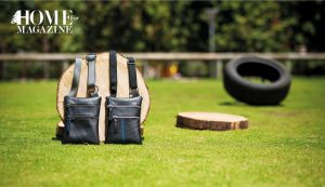 2 bags in black with a 2 woods and a black wheel on grass