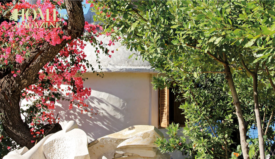a house with trees around one green and one red color