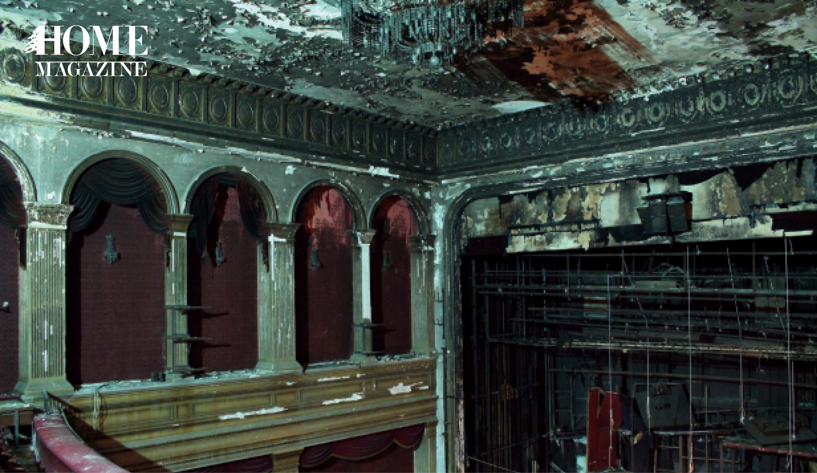 Damaged interior theater with grey walls and red furniture