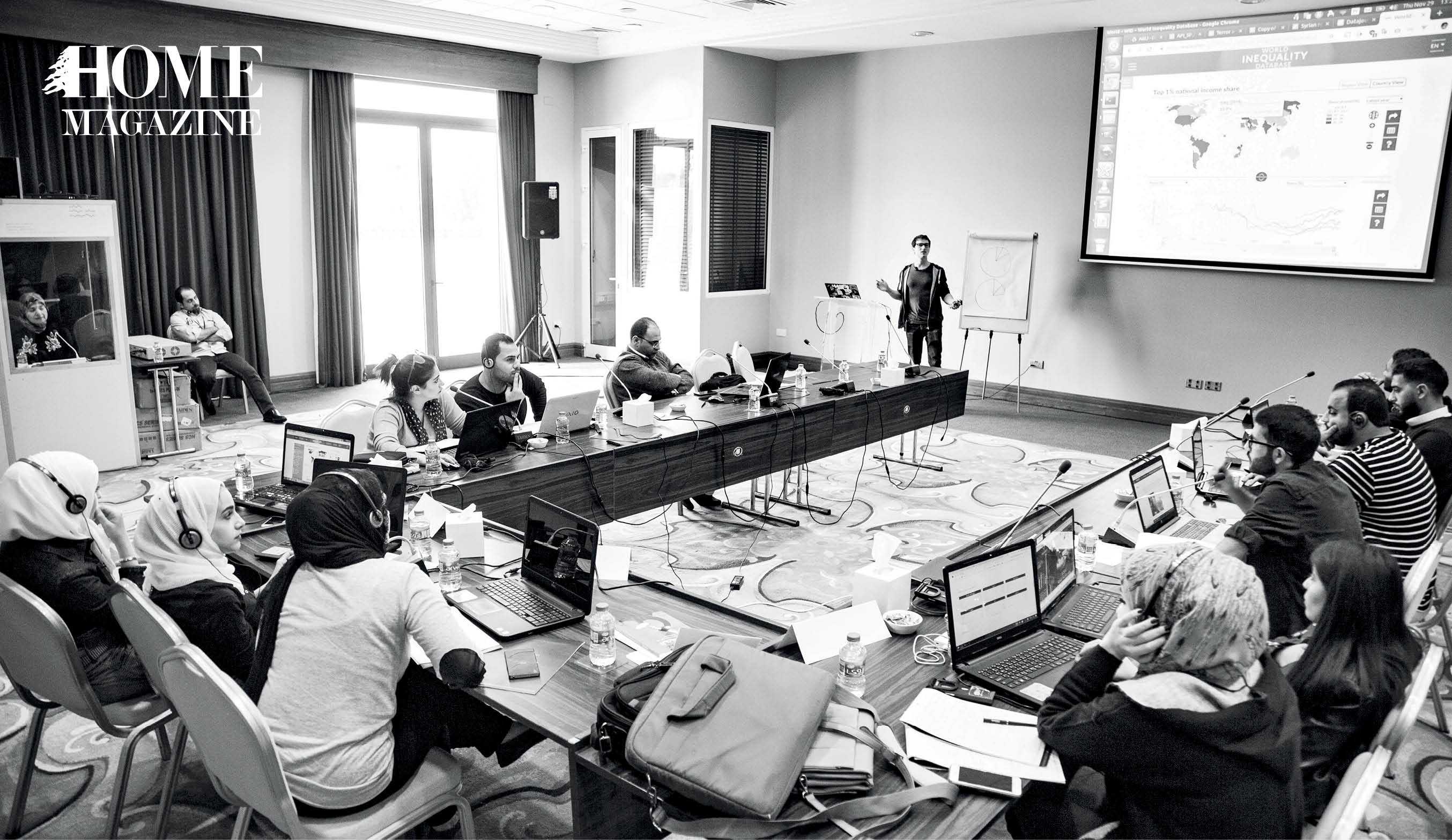 Round-table, crowd, presenter and screen