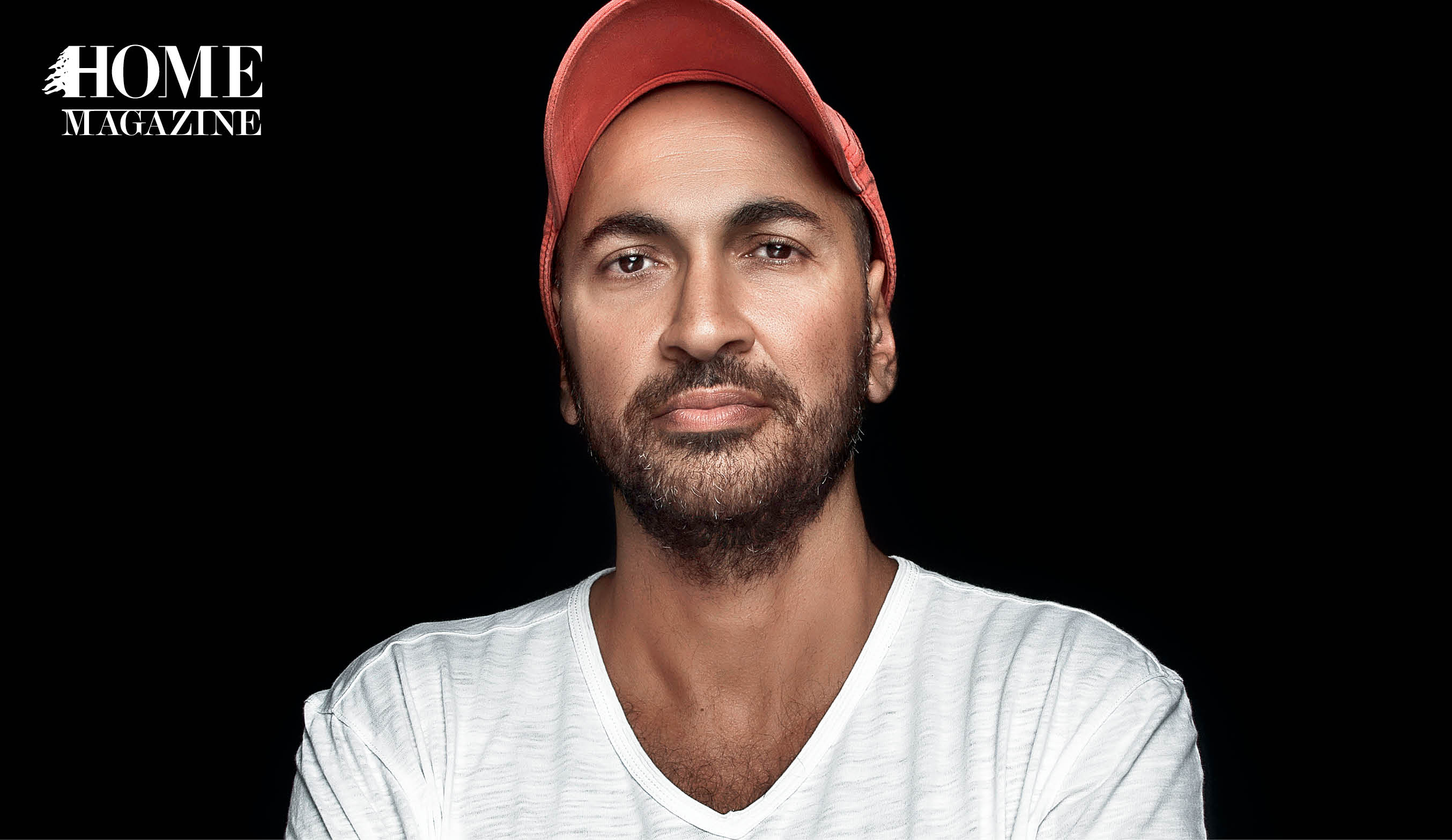 Man with crossed hands in white tshirt and red hat
