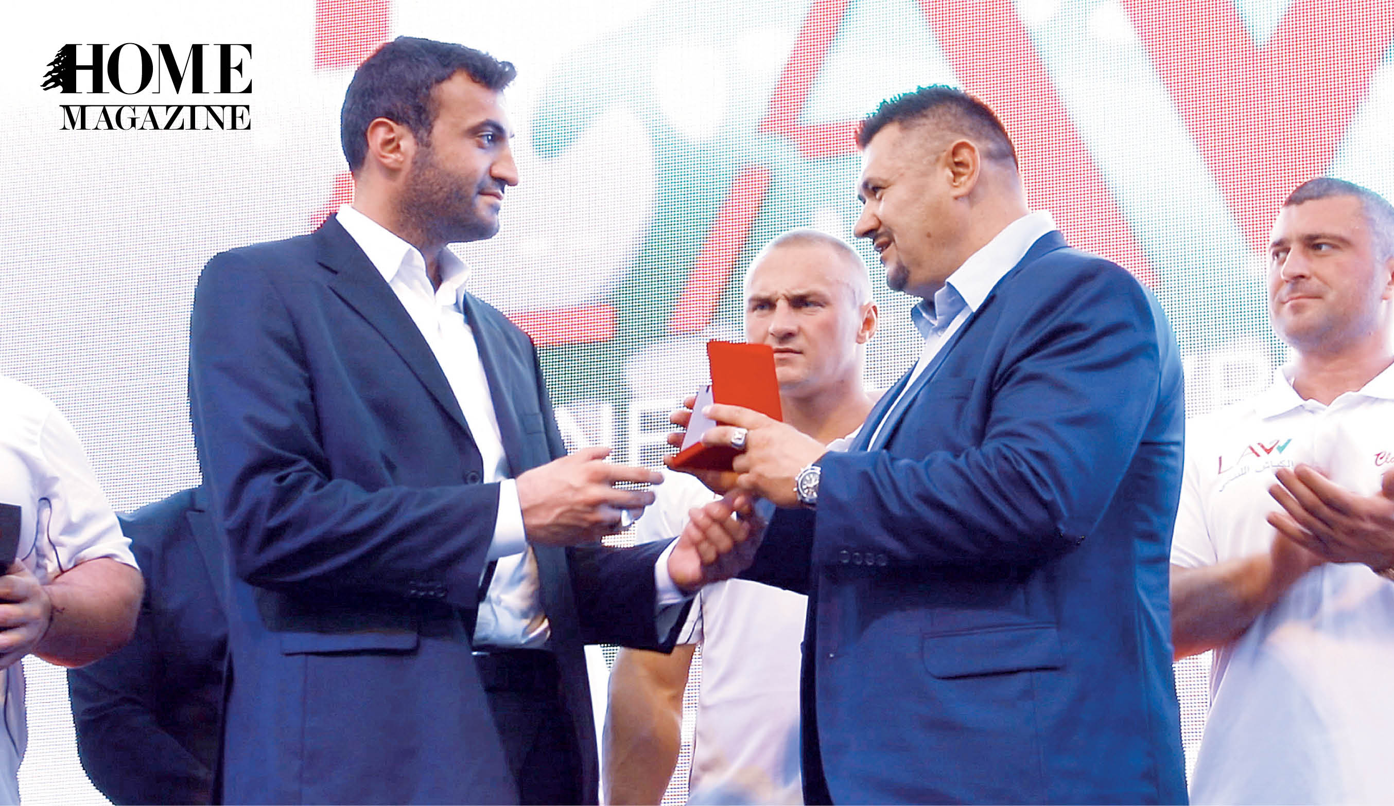 Man in suit receiving award on stage