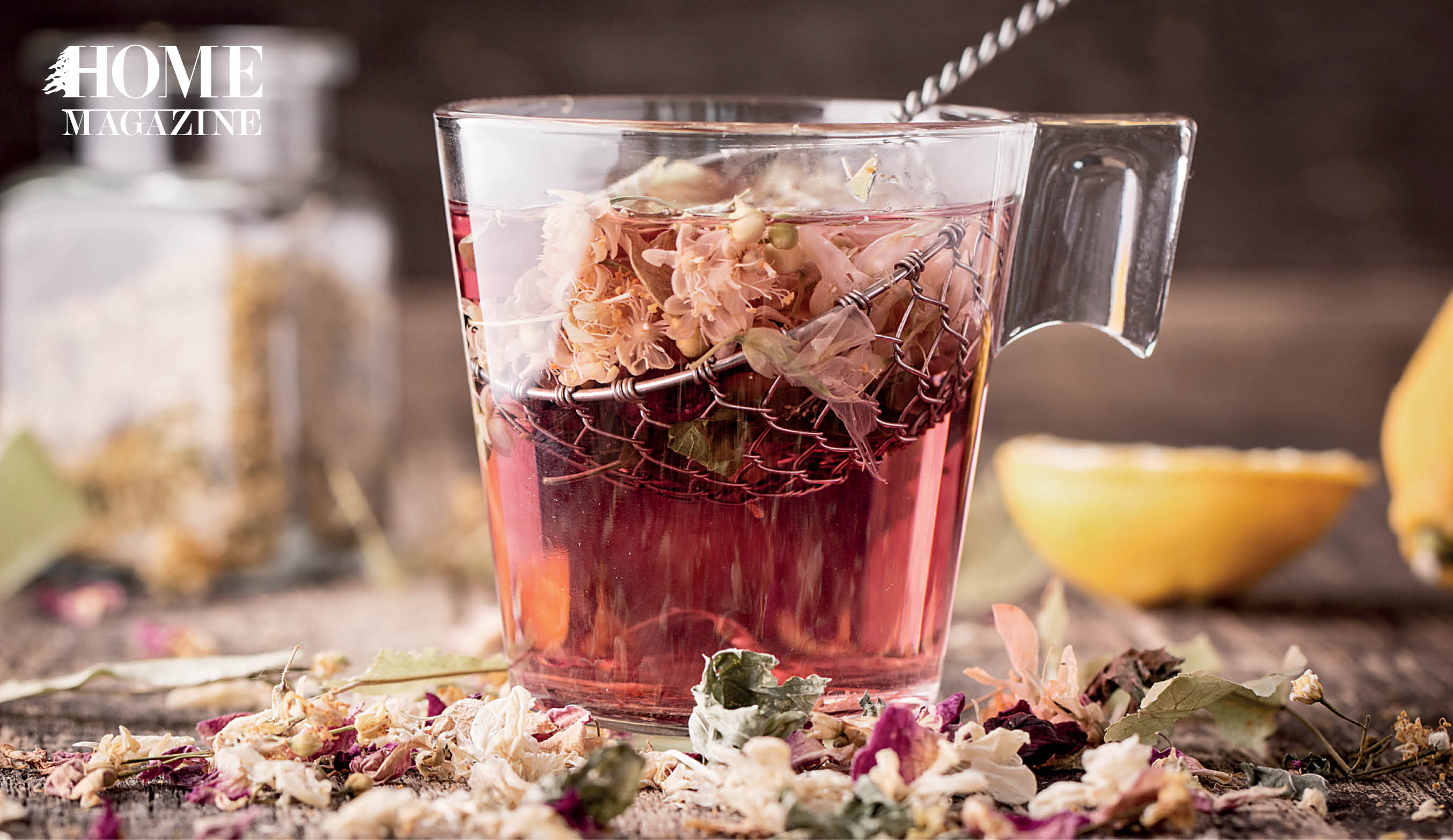 Flower herbs and brown liquid in a cup