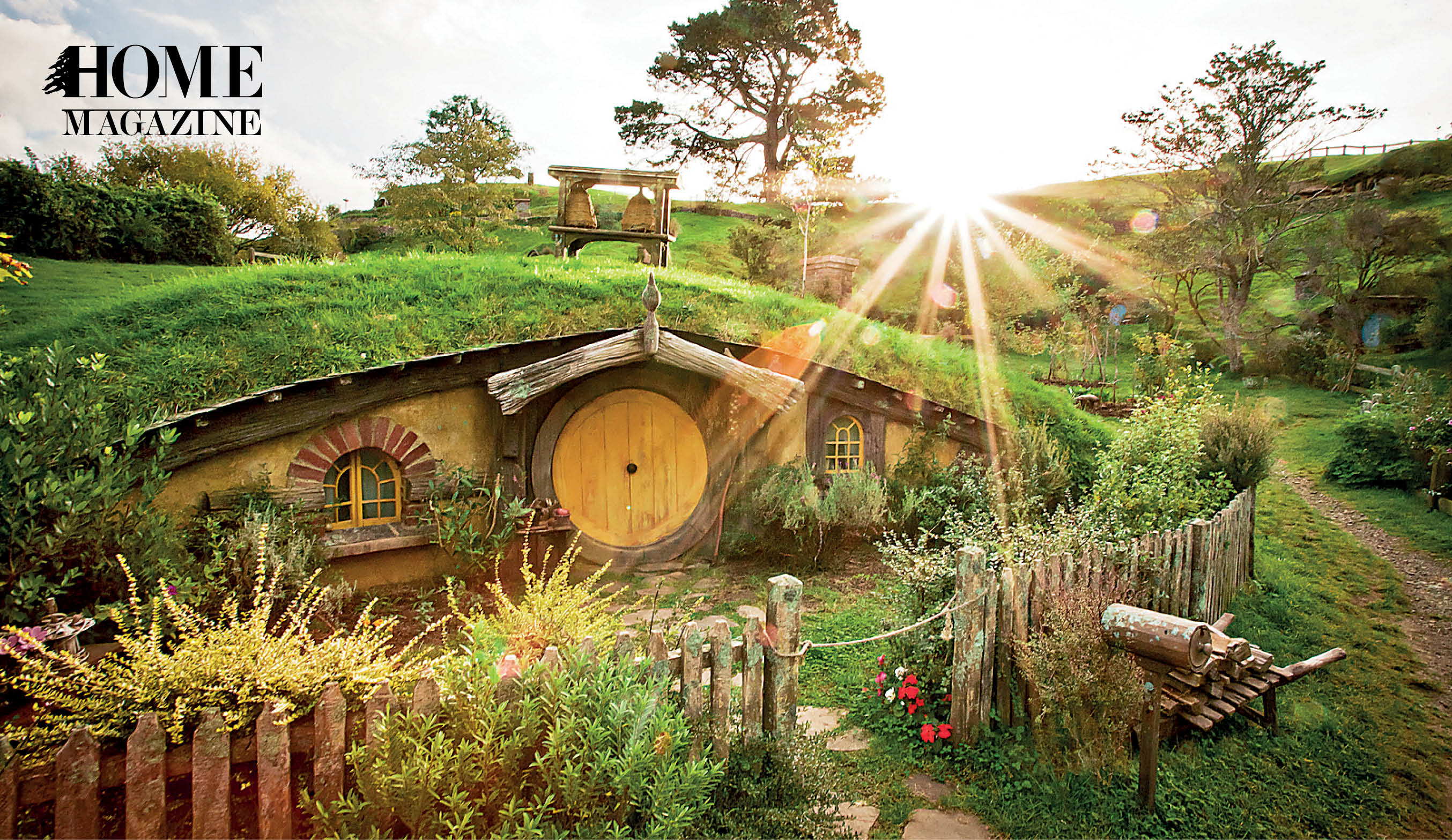Green landscape of grass and trees with a wood houses