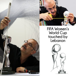 a man wearing black with eye glasses looking at the trophy with a measuring tape in his hand