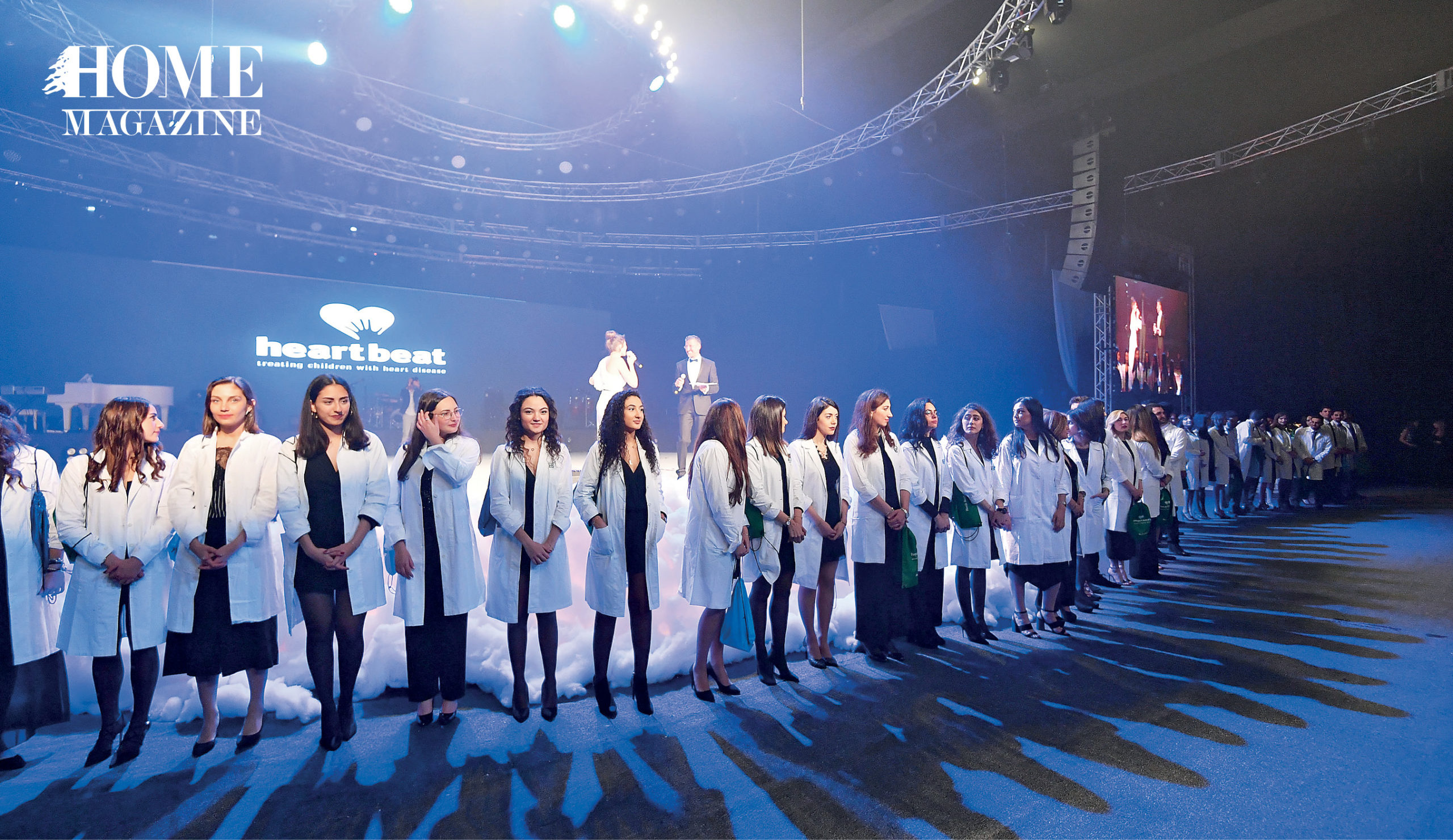 A group of people wearing white robes on a stage