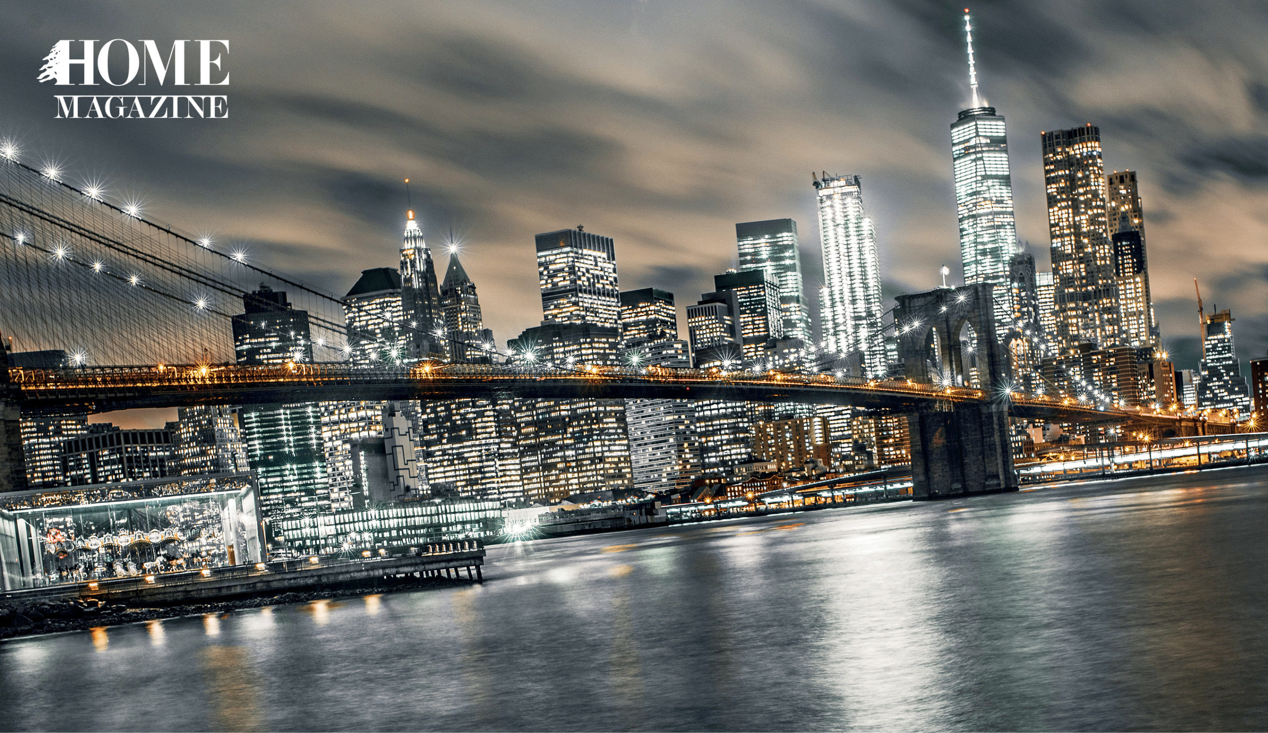 A bridge crossing waters amidst lightened buildings