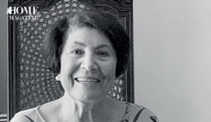 Old woman smiling on a chair