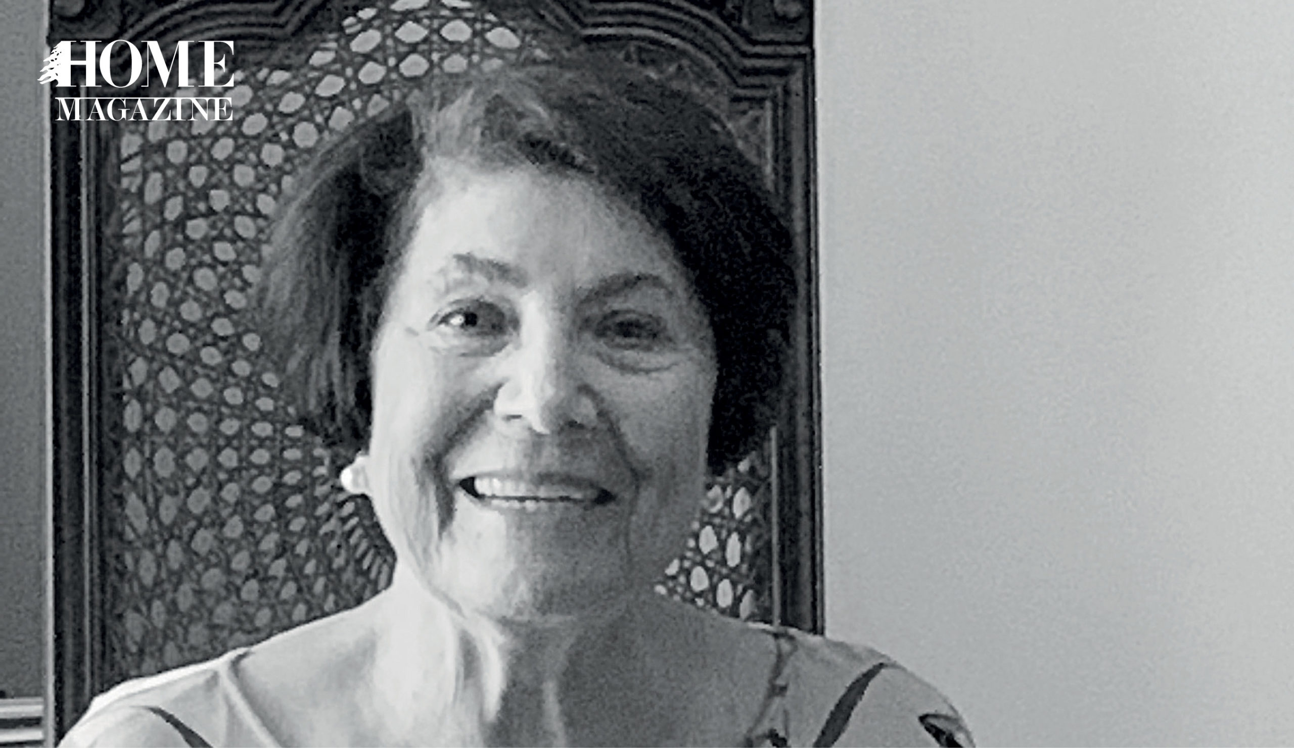 Old woman smiling on a chair