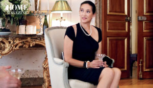 Woman in black dress sitting on a chair in salon