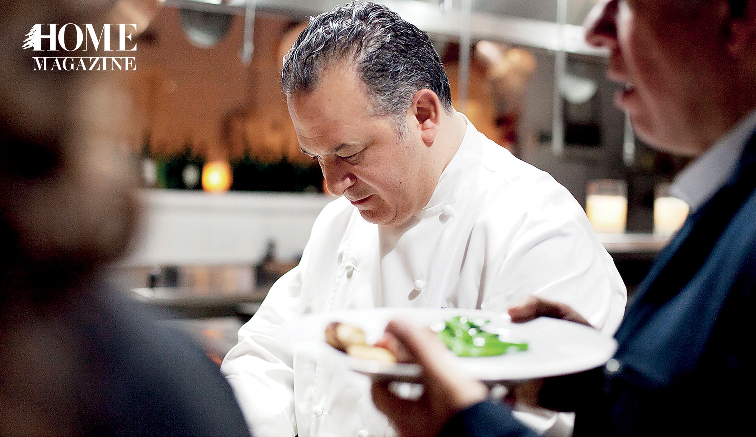 Man wearing white coat cooking