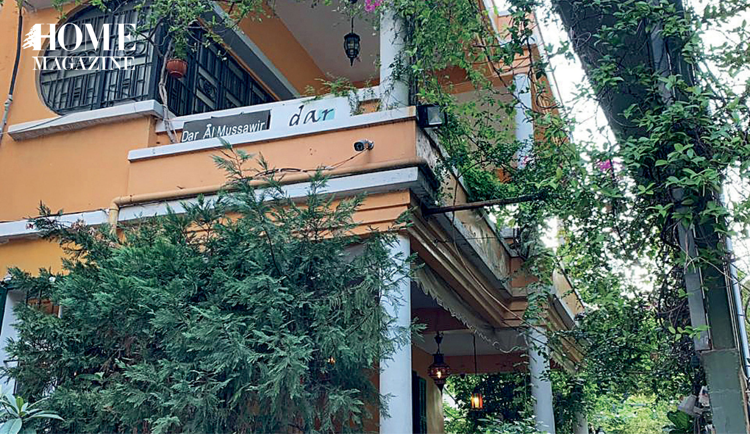 Orange painted building with green trees and plants