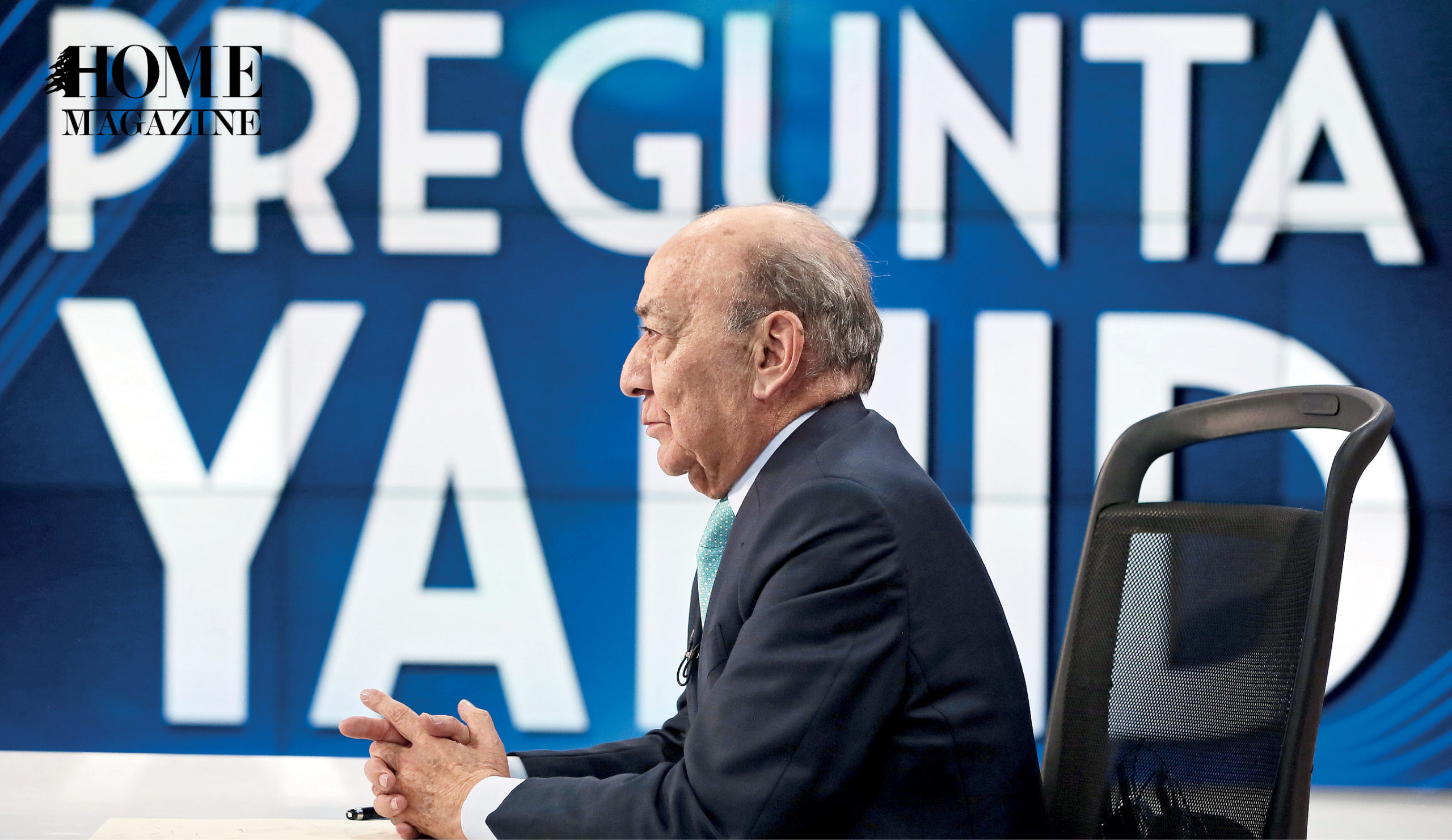 Profile of a bald man in a suit sitting on a chair with text background in blue color