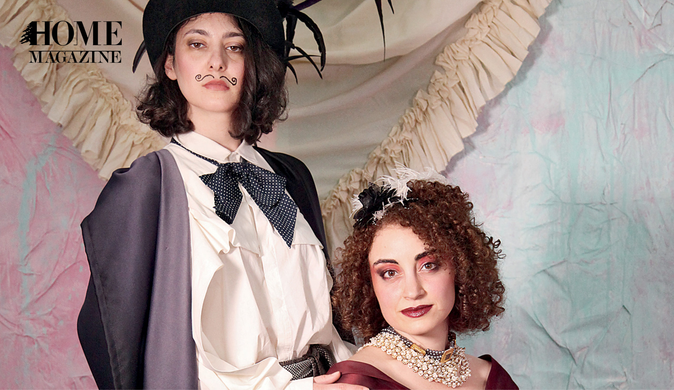 Two women with curly hair and fashion accessories