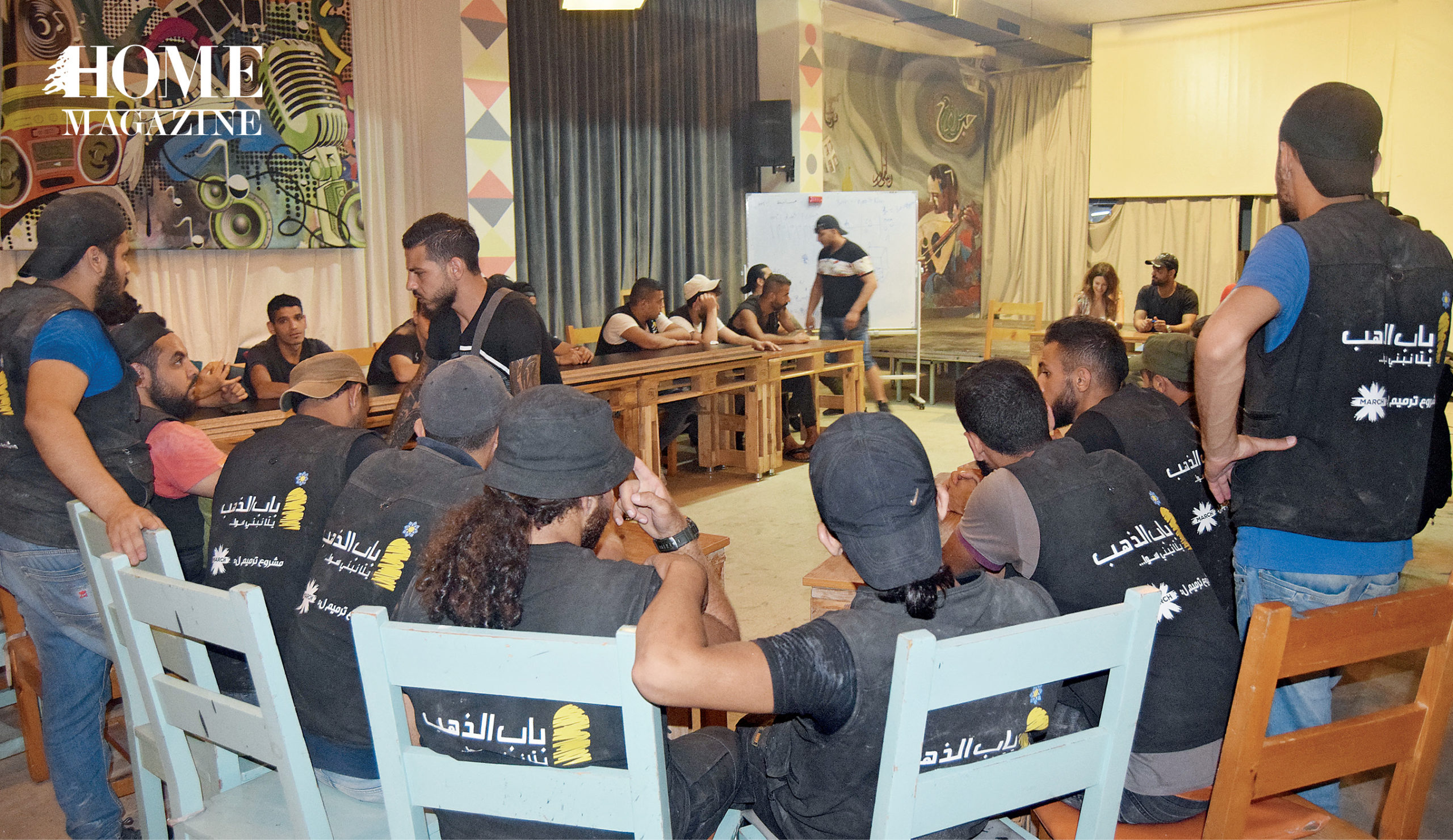 Group of people wearing black shirts and hats on a round chair table