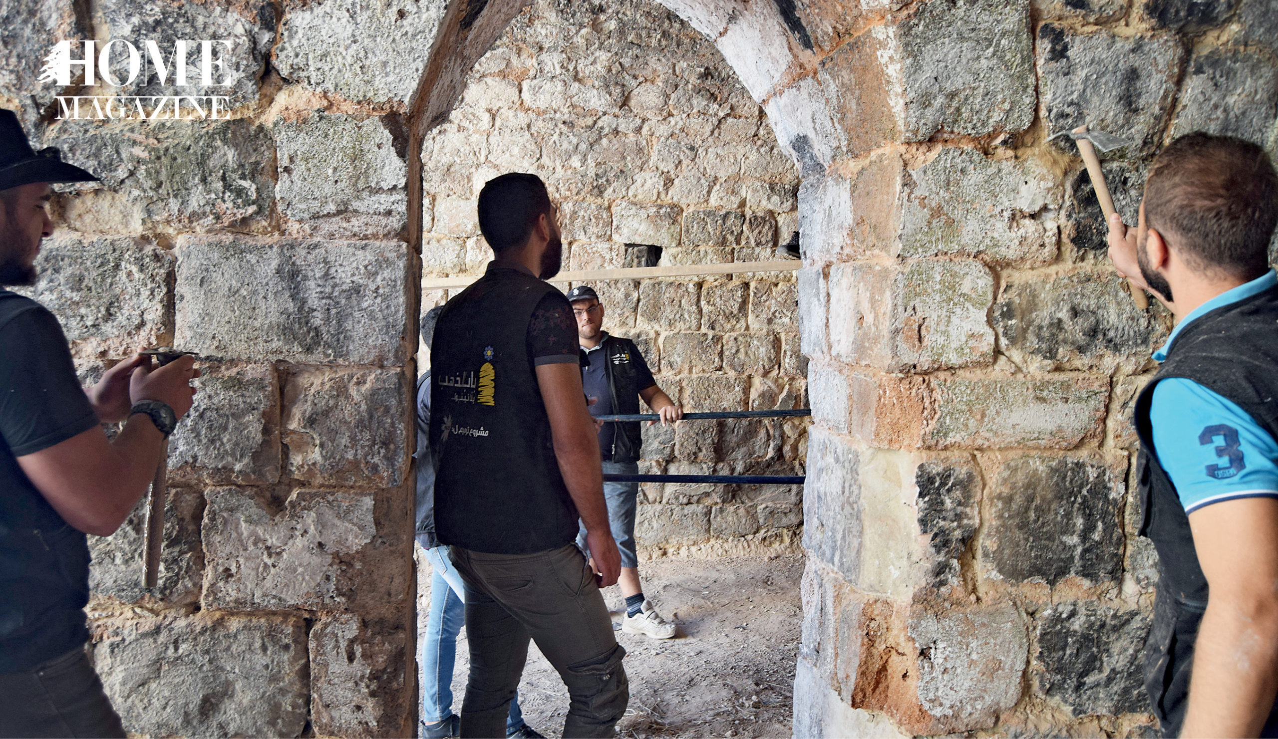 Four men amidst walls of grey rocks 