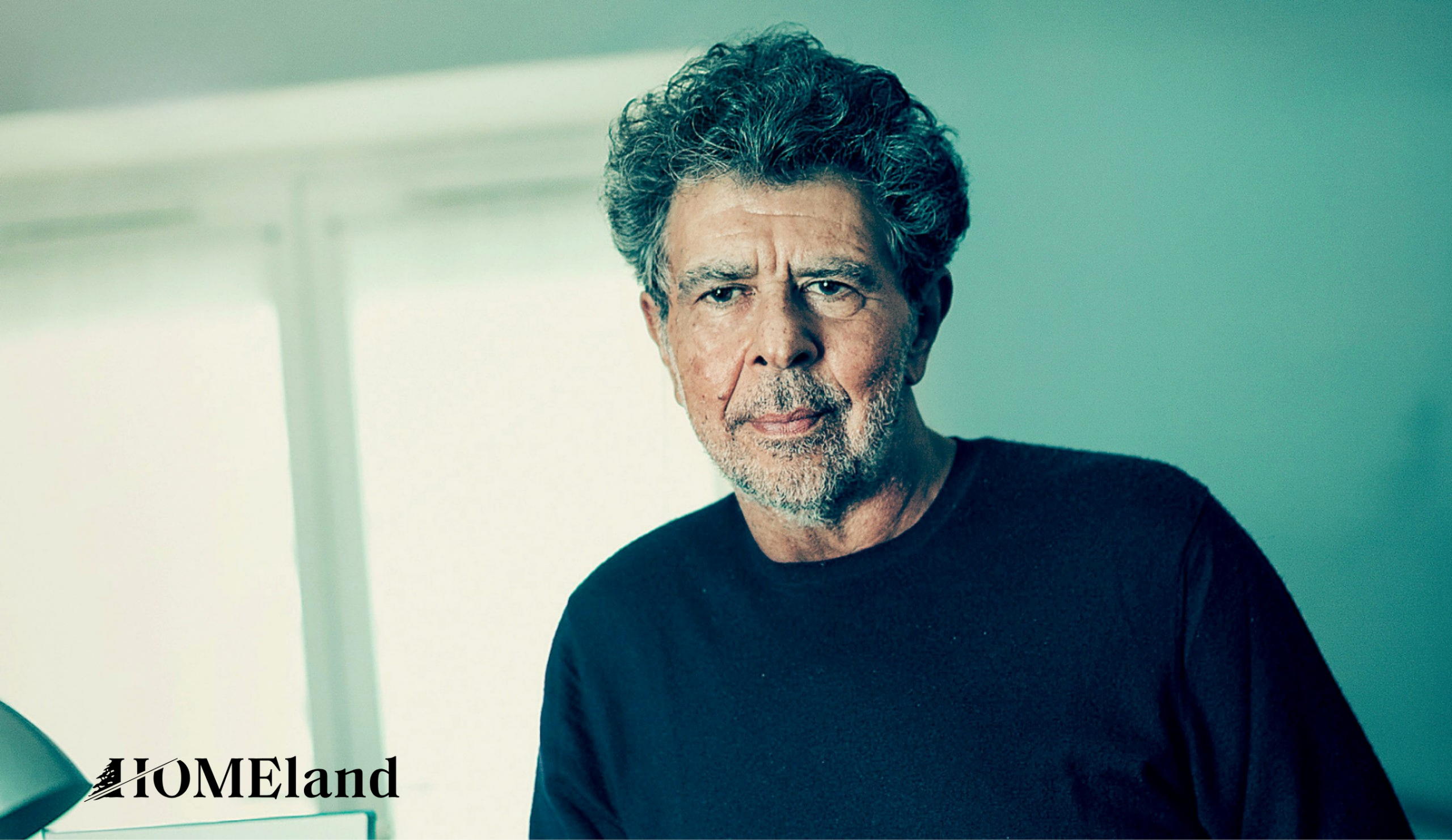 Man with curly hair in black shirt